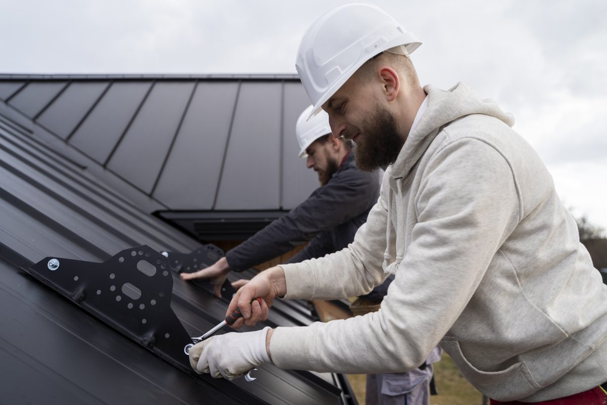 men working on a roof edge guard